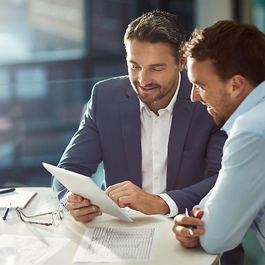 Two businessmen looking at a tablet